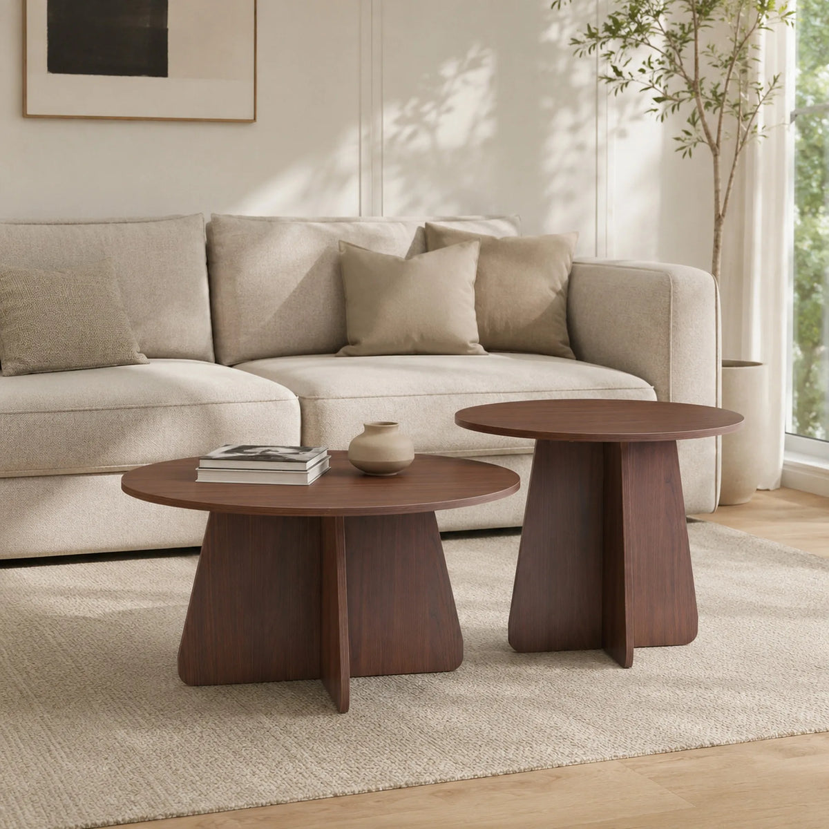 Retro-style nesting coffee table set. Available in walnut or natural wood finishes. Round nesting side tables with crisscross le